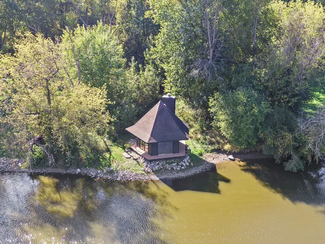 a backyard of a house with a yard and outdoor seating