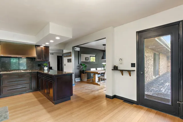 a kitchen with stainless steel appliances granite countertop a refrigerator and stove