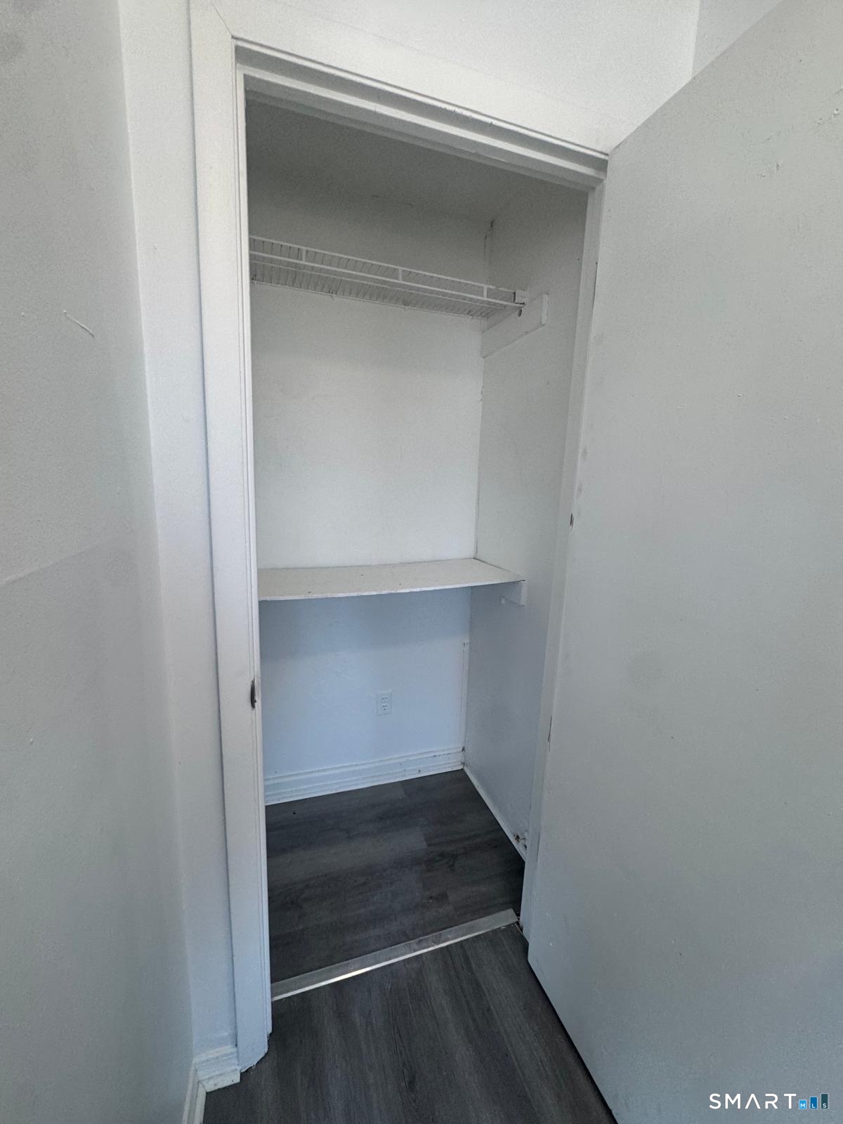 265 6th Street Bridgeport, CT 06607 - Photo 6 of 9 a storage room with an empty racks