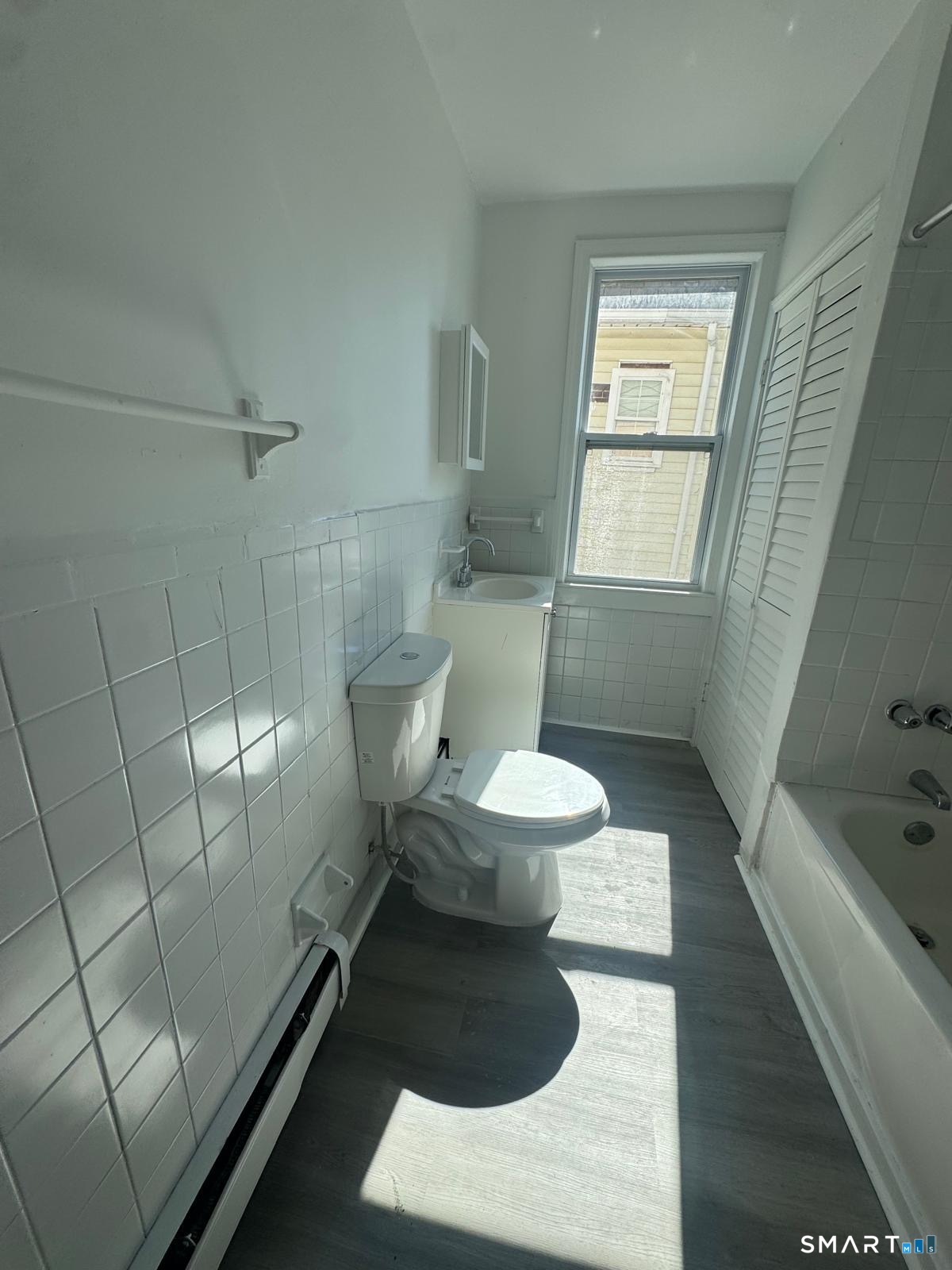 265 6th Street Bridgeport, CT 06607 - Photo 8 of 9 a bathroom with a toilet and a shower