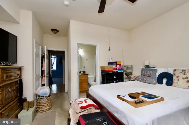 a bedroom with furniture and a lamp