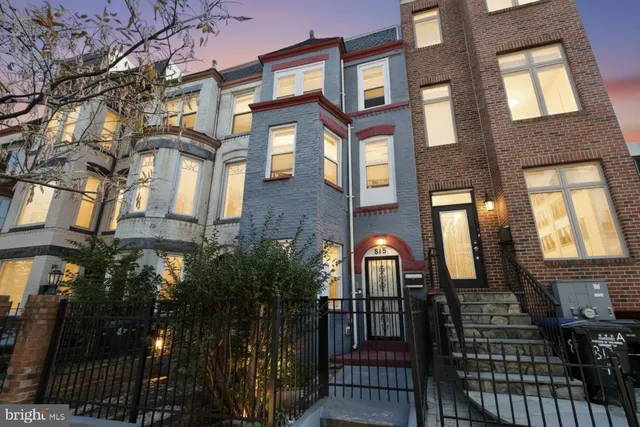 a view of a brick house with many windows