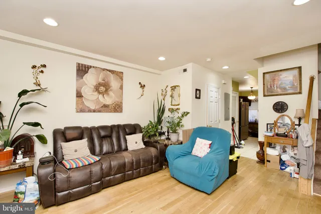 a living room with furniture and wall paintings