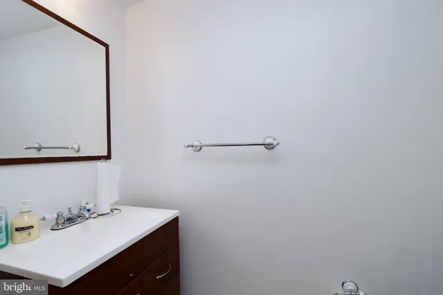 a bathroom with a sink vanity and a mirror