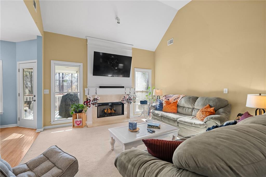 8935 Mountain Ridge Circle Ball Ground, GA 30107 - Photo 11 of 56 a living room with furniture a fireplace and a flat screen tv