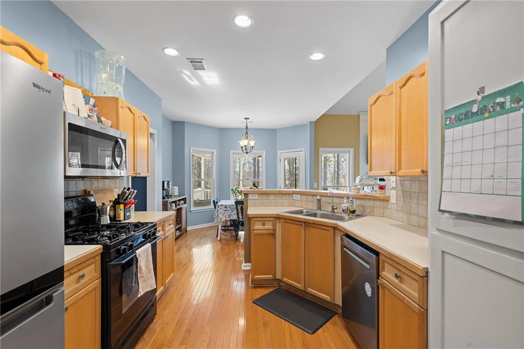 8935 Mountain Ridge Circle Ball Ground, GA 30107 - Photo 14 of 56 a kitchen with lots of counter top space and wooden floor