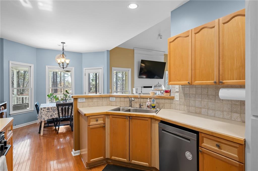 8935 Mountain Ridge Circle Ball Ground, GA 30107 - Photo 15 of 56 a kitchen with kitchen island granite countertop a sink stove and cabinets