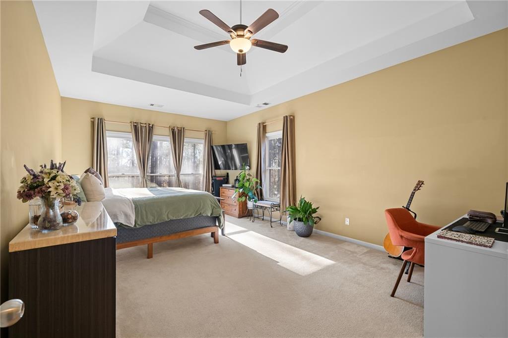 8935 Mountain Ridge Circle Ball Ground, GA 30107 - Photo 17 of 56 a bedroom with a bed and a chandelier