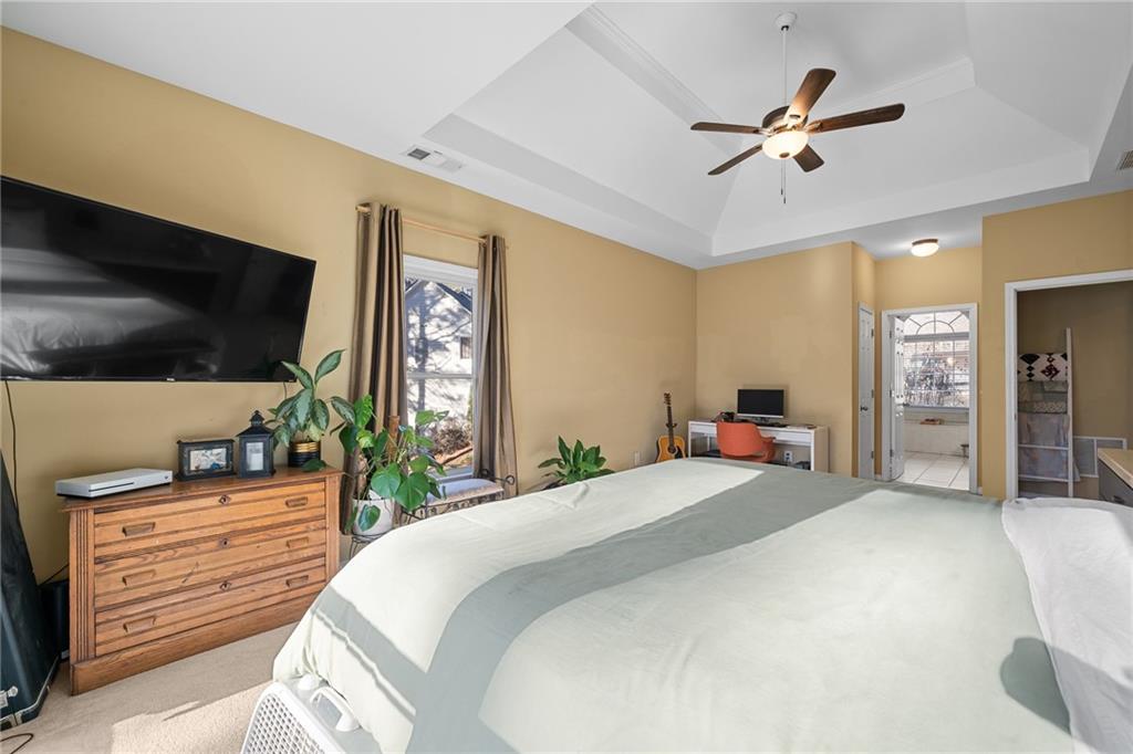 8935 Mountain Ridge Circle Ball Ground, GA 30107 - Photo 18 of 56 a bedroom with a bed a dresser and potted plants