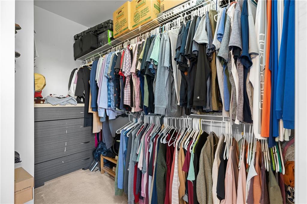8935 Mountain Ridge Circle Ball Ground, GA 30107 - Photo 22 of 56 a view of walk in closet with clothes and shoes
