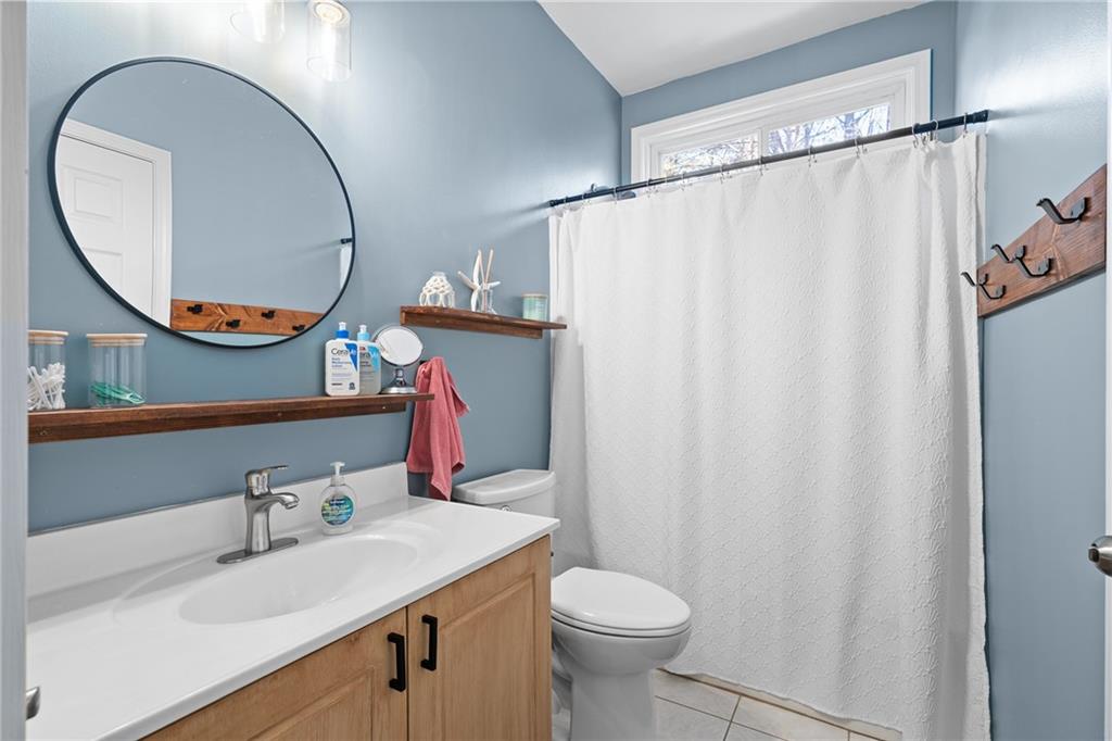 8935 Mountain Ridge Circle Ball Ground, GA 30107 - Photo 26 of 56 a bathroom with a sink vanity mirror and toilet