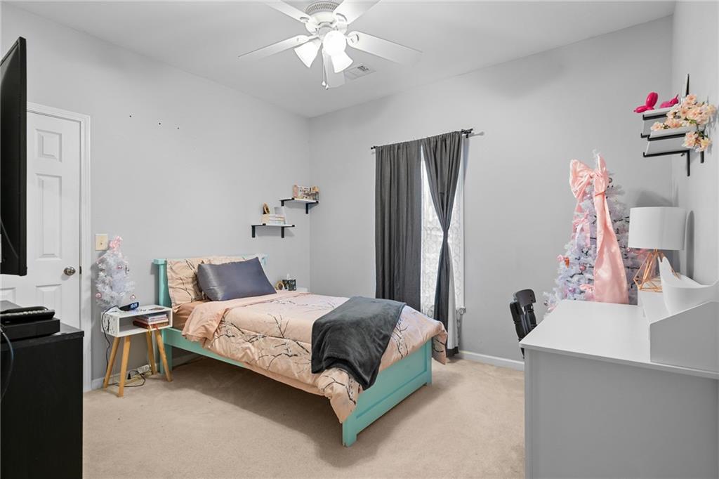 8935 Mountain Ridge Circle Ball Ground, GA 30107 - Photo 27 of 56 a bedroom with a bed and a chandelier