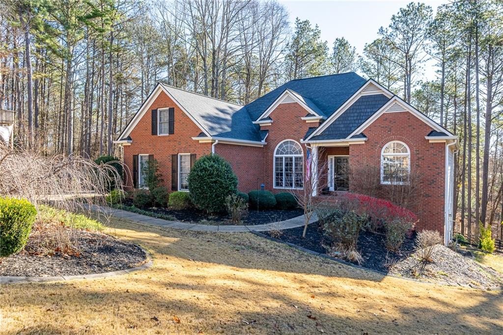 8935 Mountain Ridge Circle Ball Ground, GA 30107 - Photo 4 of 56 a front view of a house with a yard and garage