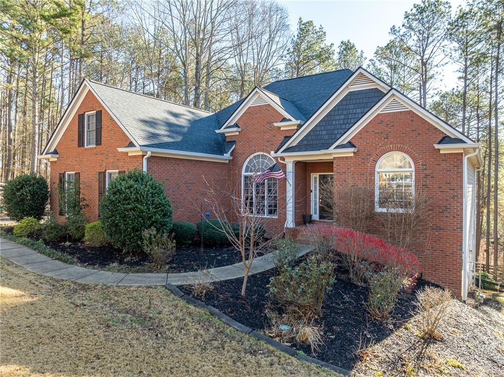 8935 Mountain Ridge Circle Ball Ground, GA 30107 - Photo 41 of 56 a front view of a house with garden