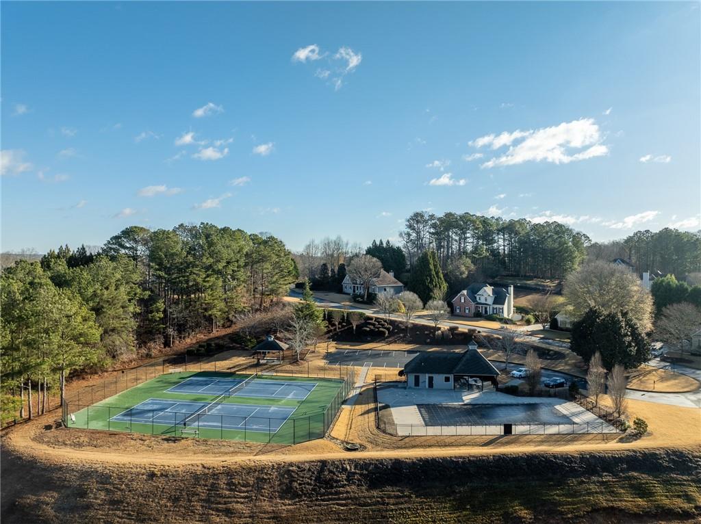 8935 Mountain Ridge Circle Ball Ground, GA 30107 - Photo 55 of 56 a view of a lake with lawn chairs and a fire pit
