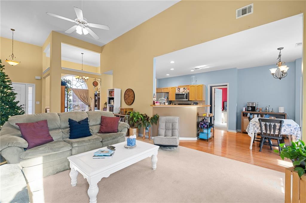8935 Mountain Ridge Circle Ball Ground, GA 30107 - Photo 10 of 56 a living room with furniture and a chandelier