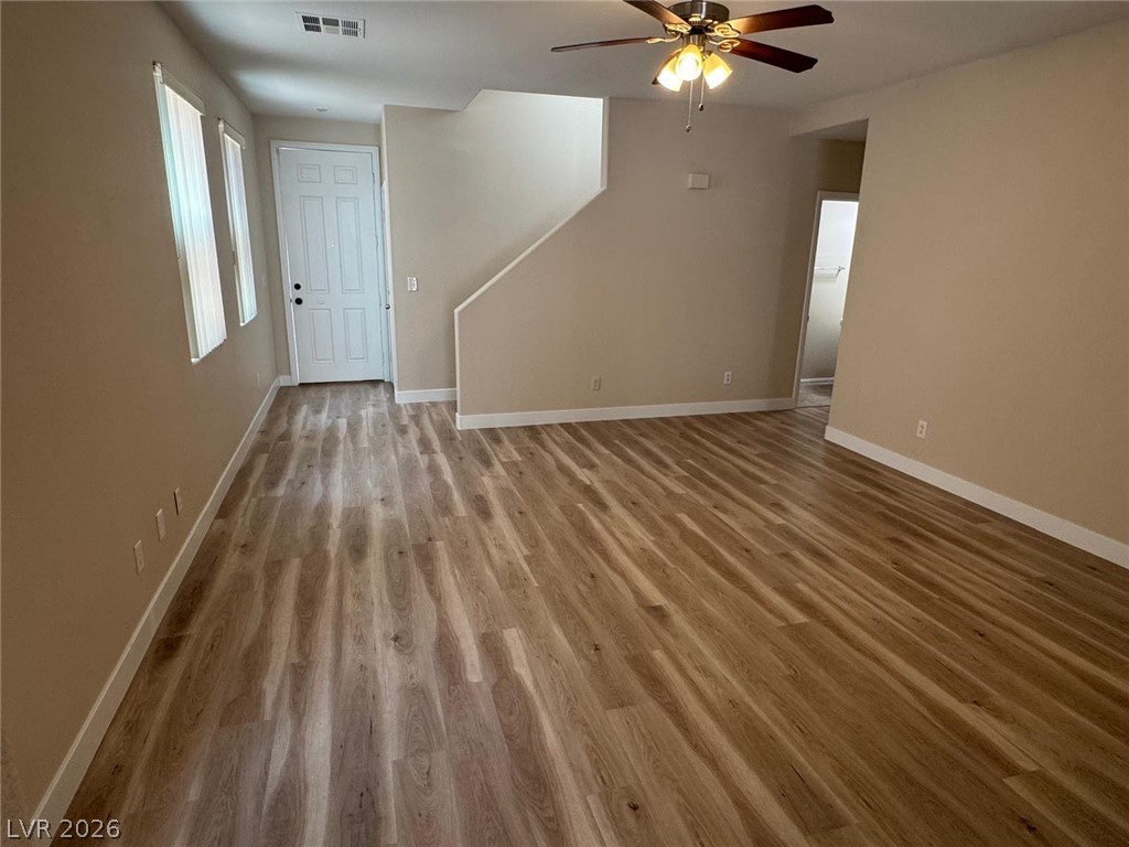 3962 Coyote Ridge Court Las Vegas, NV 89129 - Photo 12 of 35 A warm, open living area showcases beautiful flooring and convenient interior access points.