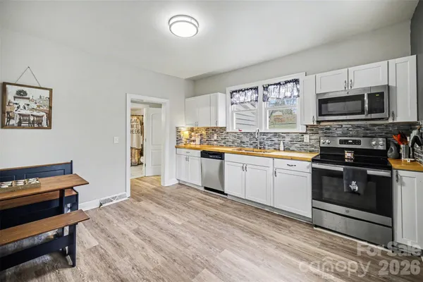 a kitchen with stainless steel appliances a stove sink and microwave