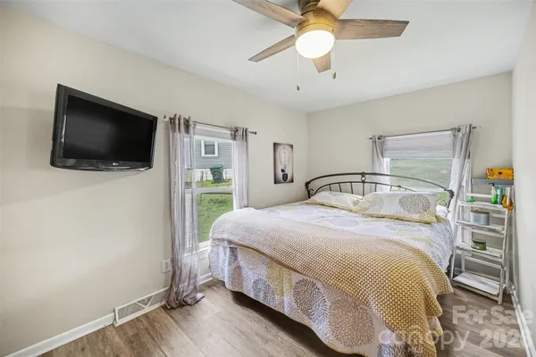 a bedroom with a bed and a flat screen tv