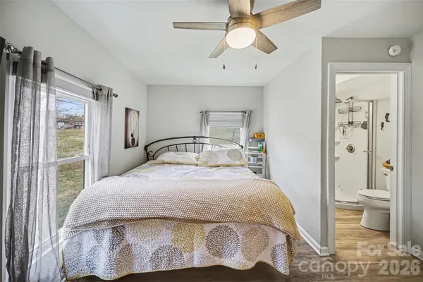 a bedroom with a bed and a view of bathroom