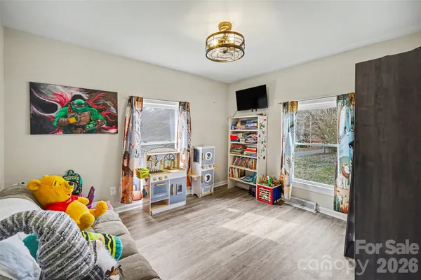 a view of a livingroom with lounge chair and a window