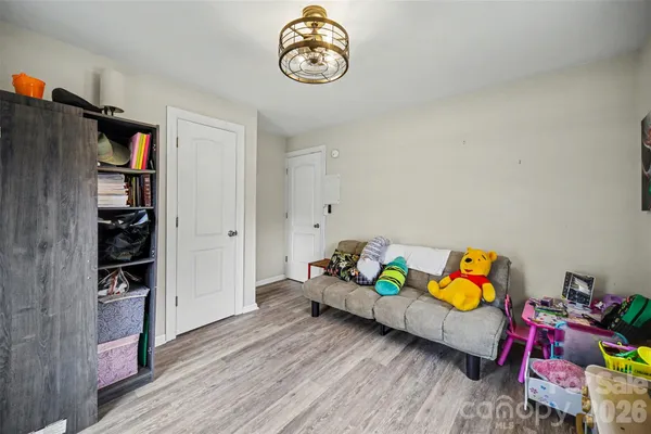 a bedroom with furniture and a book shelf
