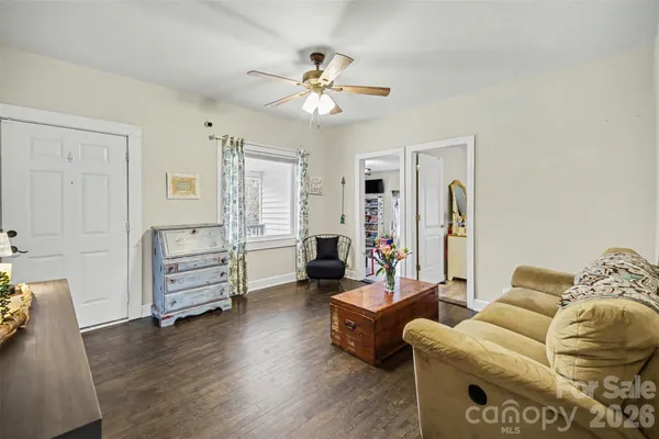 a living room with furniture and wooden floor