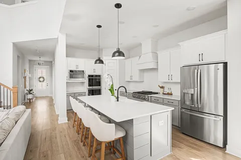 a open kitchen with a sink a counter top space stainless steel appliances and a window