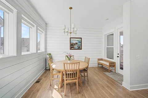 a bedroom with a bed a couch and a chandelier
