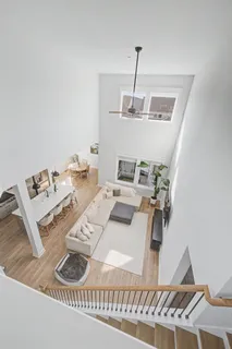 a view of a patio with couches table and chairs with wooden floor and fence