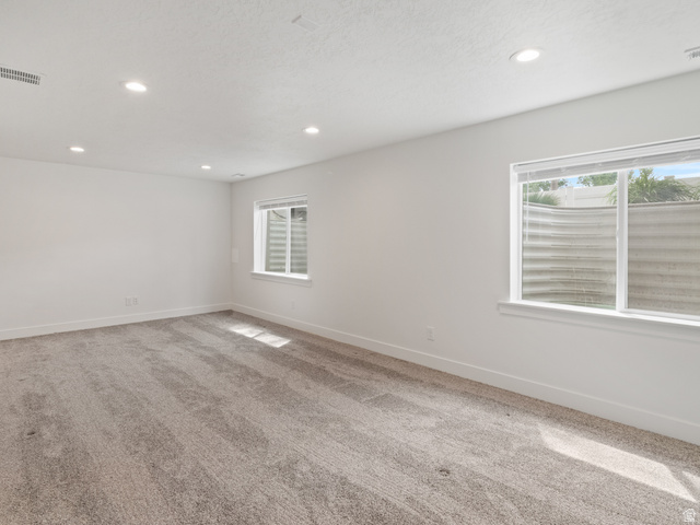 130 East 7085th South, Unit 3 Midvale, UT 84047 - Photo 24 of 30 Empty room with light carpet, plenty of natural light, and recessed lighting