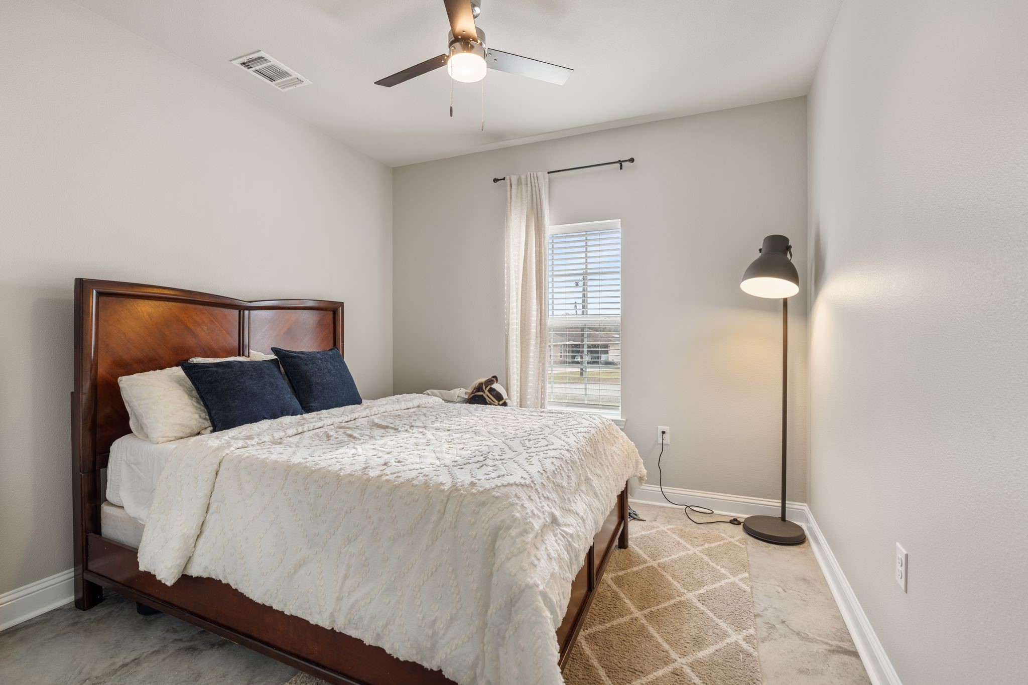 413 East Spruce Street Huntington, TX 75949 - Photo 13 of 37 a bedroom with a bed and a chandelier