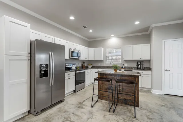 a kitchen with cabinets and stainless steel appliances