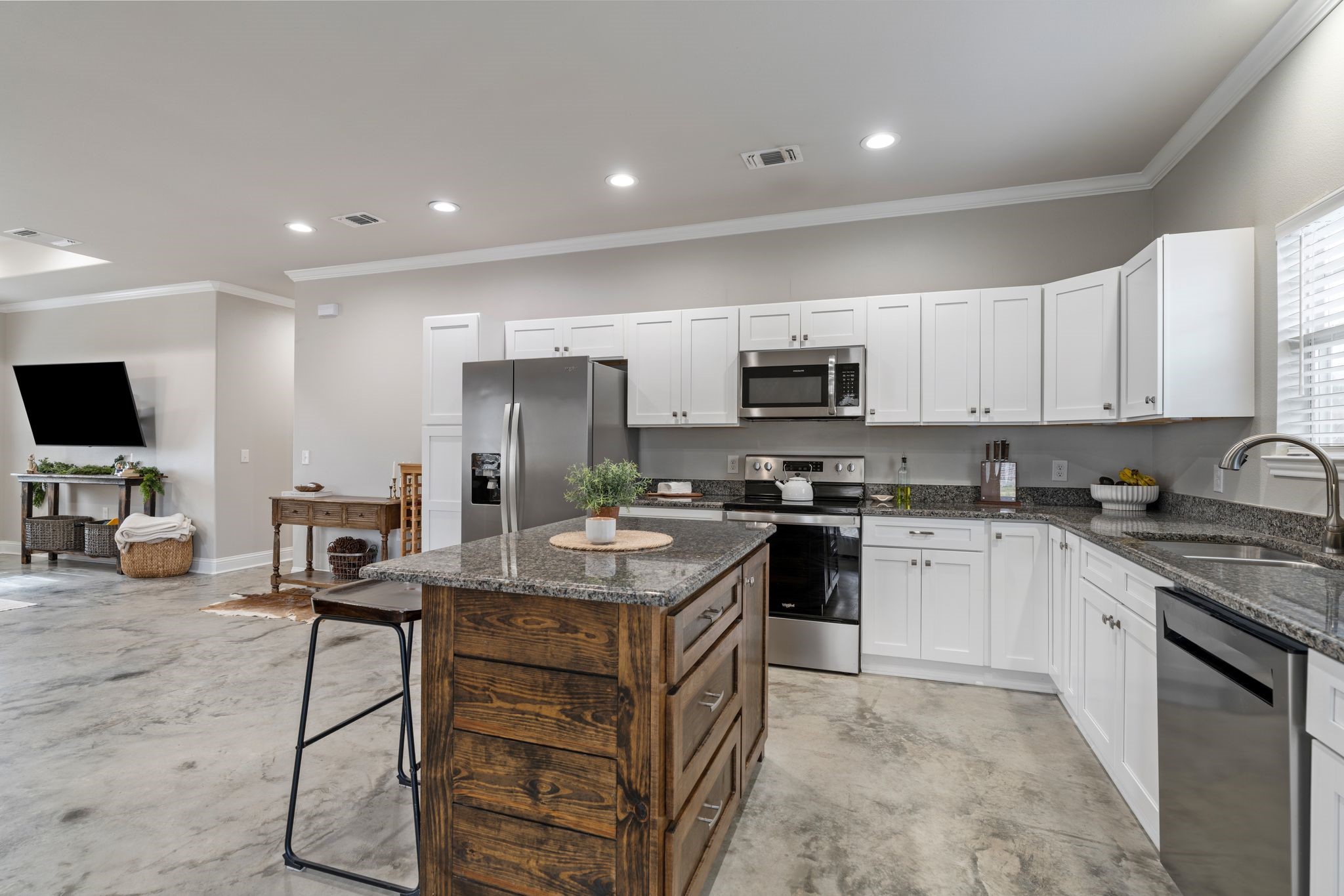 413 East Spruce Street Huntington, TX 75949 - Photo 3 of 37 a kitchen with a sink a microwave and cabinets
