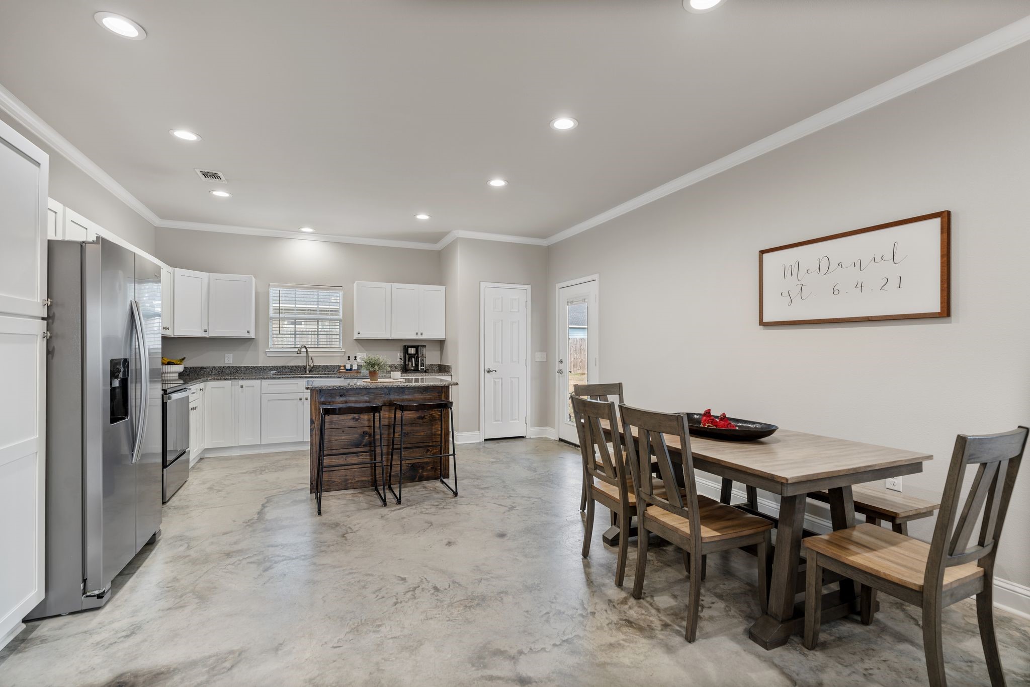 413 East Spruce Street Huntington, TX 75949 - Photo 7 of 37 a kitchen with kitchen island a dining table and chairs