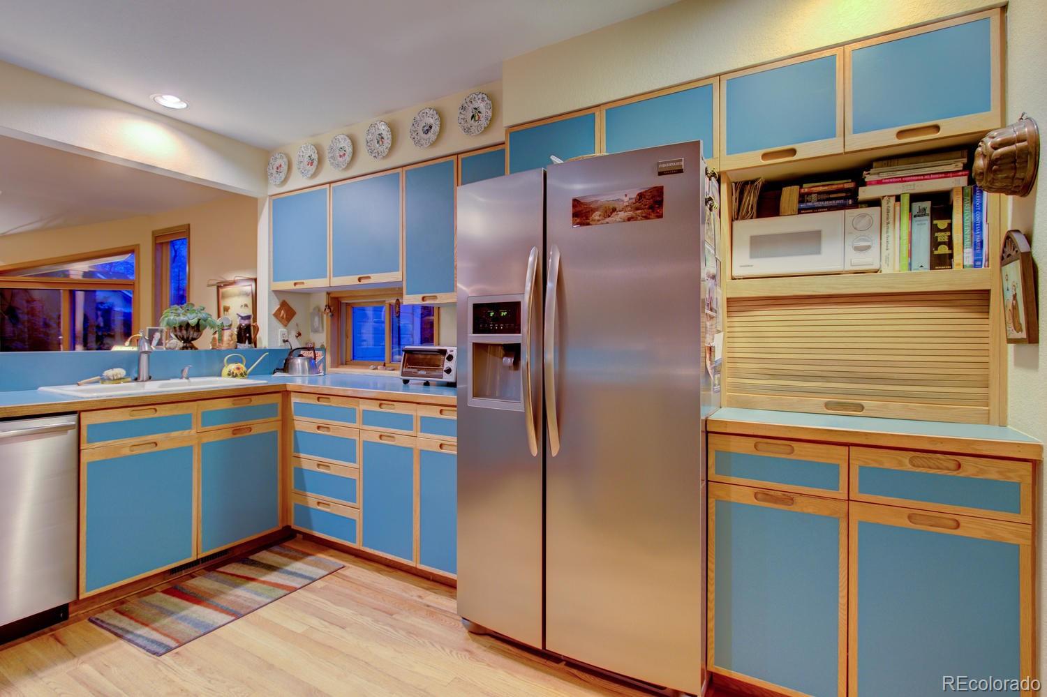 2313 Mapleton Avenue Boulder, CO 80304 - Photo 22 of 35 a kitchen with stainless steel appliances granite countertop a refrigerator and a sink