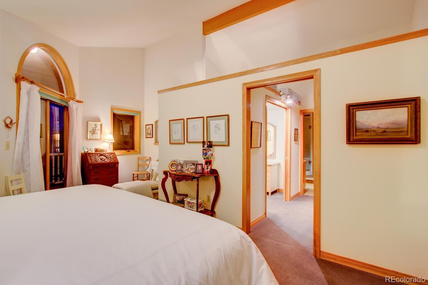 2313 Mapleton Avenue Boulder, CO 80304 - Photo 32 of 35 a bedroom with a bed and a chandelier