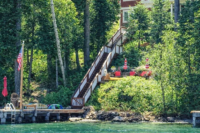 a view of a house with a yard and potted plants