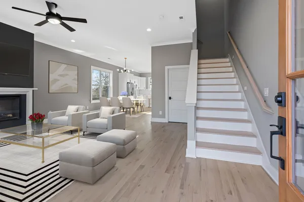 a living room with furniture and a wooden floor