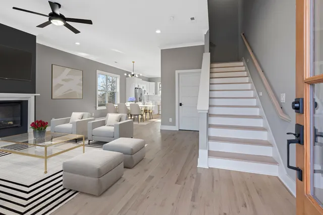 a living room with furniture and a wooden floor