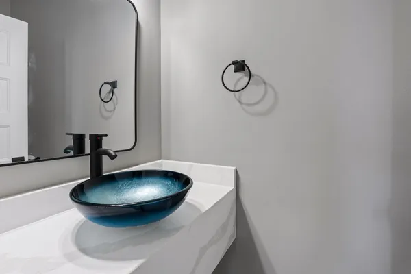 a bathroom with a sink and mirror