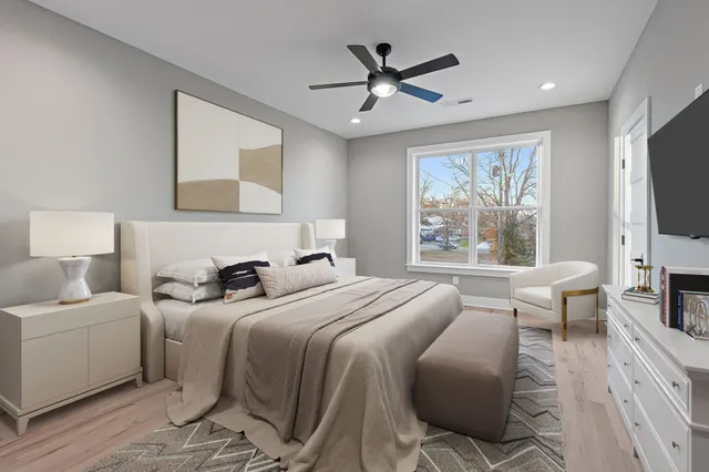 a bedroom with a large bed and a flat screen tv