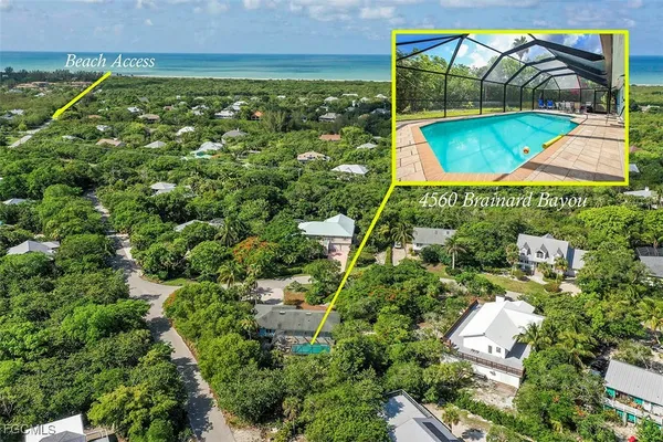 an aerial view of residential houses with outdoor space and swimming pool