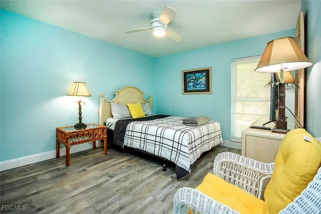 a bedroom with bed and a chandelier