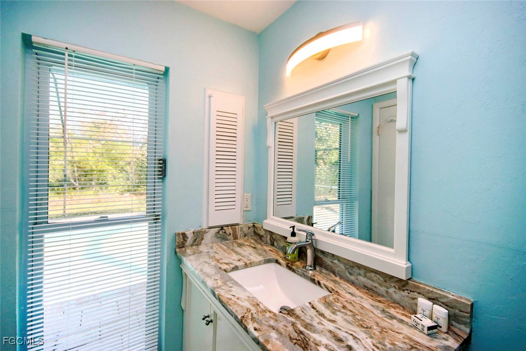 4560 Brainard Bayou Road Sanibel, FL 33957 - Photo 18 of 32 a spacious bedroom with a bed and a window