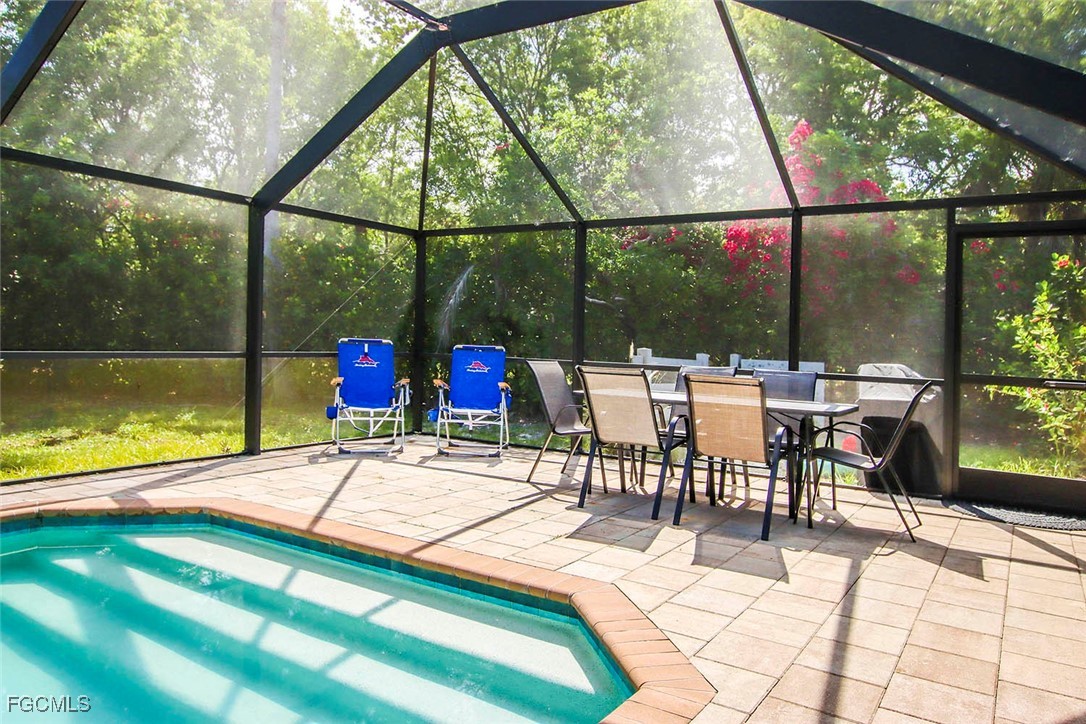 4560 Brainard Bayou Road Sanibel, FL 33957 - Photo 28 of 32 a view of a swimming pool with a table and chairs