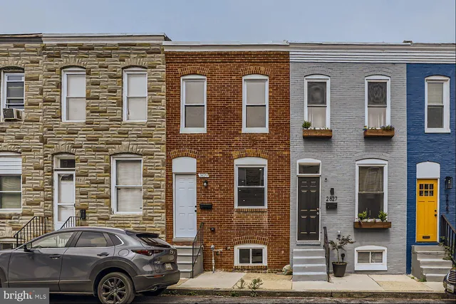 a front view of a house with parking space