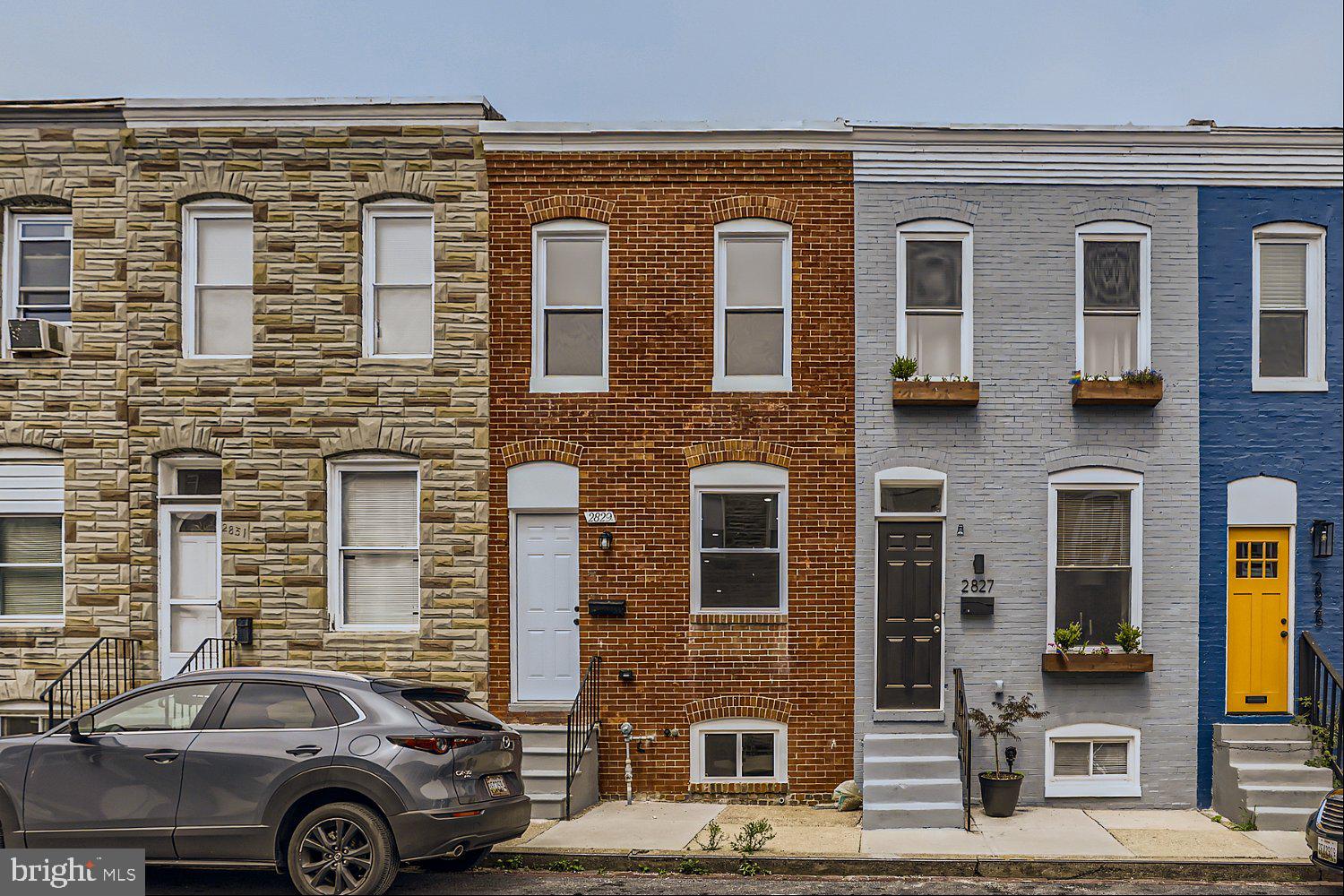 2829 Miles Avenue Baltimore, MD 21211 - Photo 1 of 25 a front view of a house with parking space
