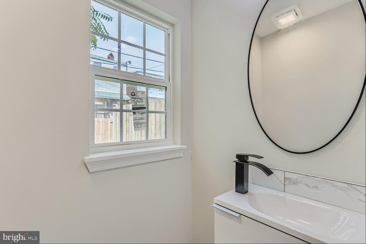 2829 Miles Avenue Baltimore, MD 21211 - Photo 13 of 25 a bathroom with a sink and a mirror