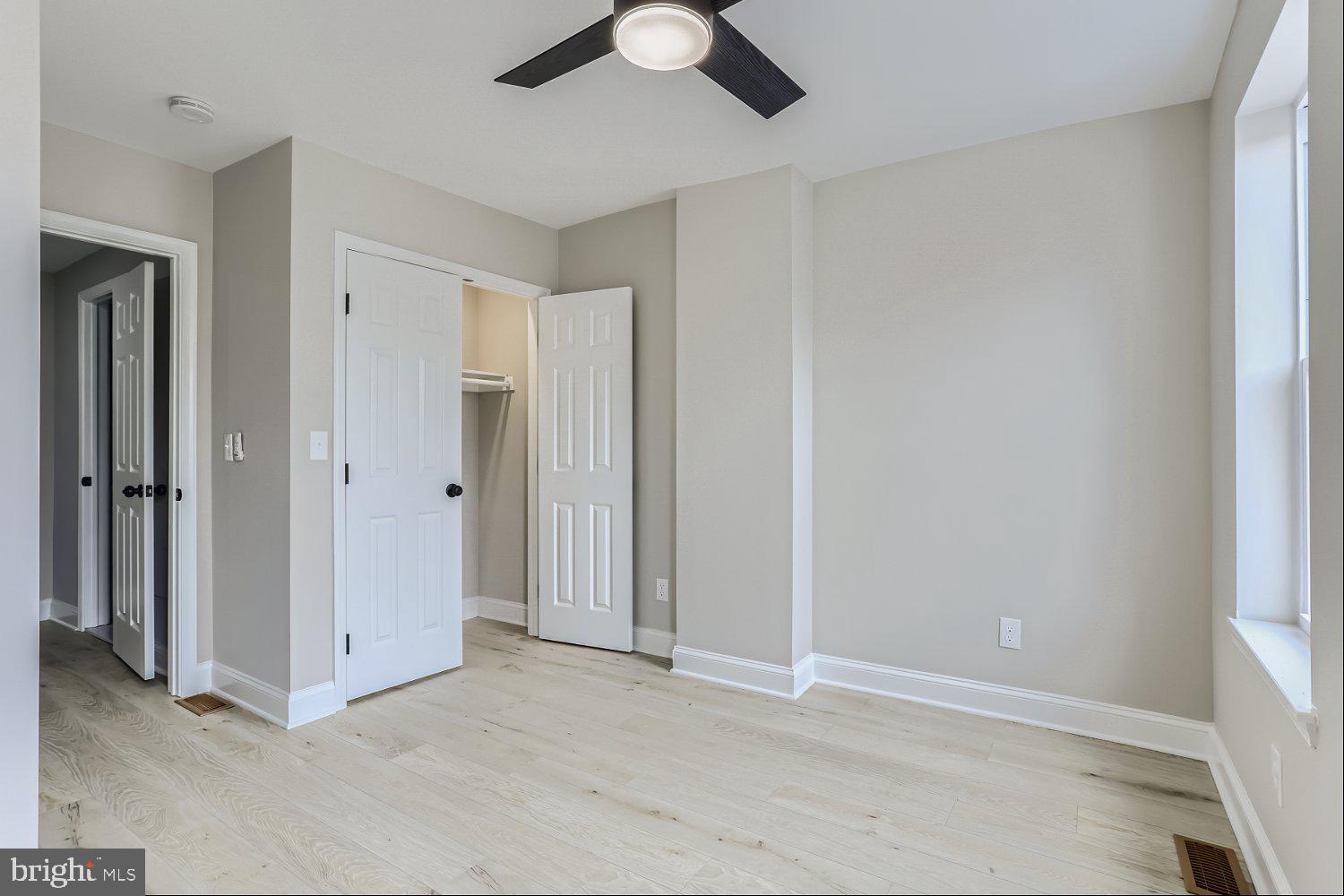 2829 Miles Avenue Baltimore, MD 21211 - Photo 15 of 25 an empty room with closet and a chandelier fan